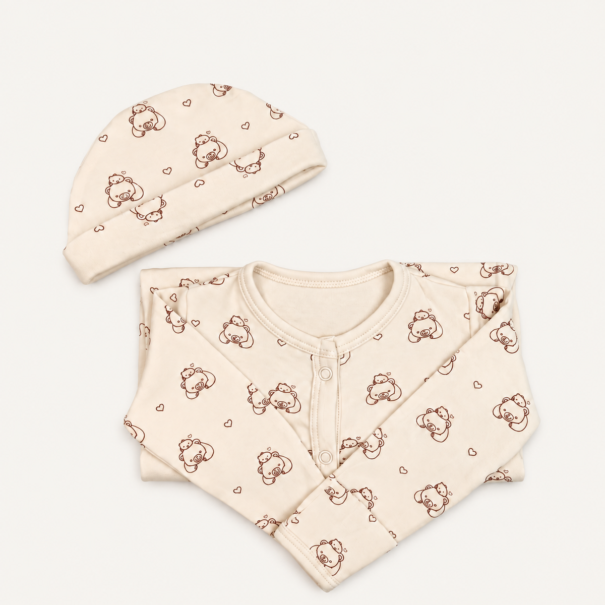 The Bear Footed Onesie, bear-and-heart print in off-white